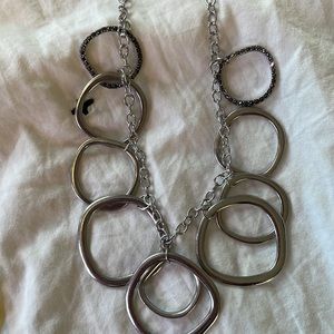 Brand new silver necklace with rings, 3 of the rings have rhinestones adjustable